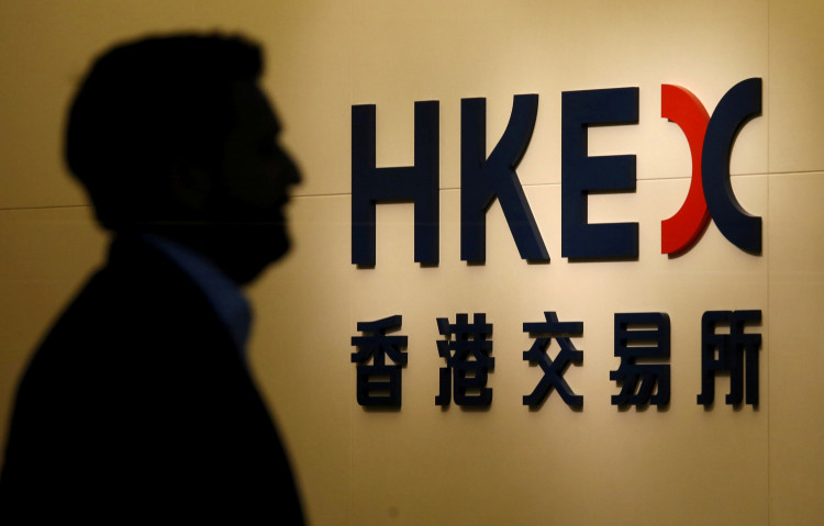 A man walks past the entrance to the Hong Kong Exchange in Hong Kong