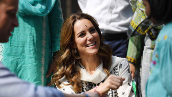 Britain's Catherine, Duchess of Cambridge receives a bracelet as she visits SOS Village in Lahore, Pakistan October 18, 2019. Picture taken October 18, 2019. Neil Hall/Pool via REUTERS