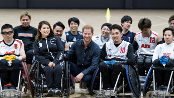 Britain's Prince Harry, Duke of Sussex, poses for a group photograph with wheelchair rugby athletes as he visits the Nippon Foundation Para Arena in Tokyo, Japan November 2, 2019. Tomohiro Ohsumi/Pool via REUTERS