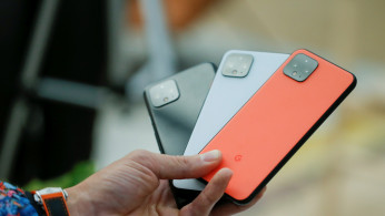 A man holds new Google Pixel 4 smartphones as they are displayed during a Google launch event New York