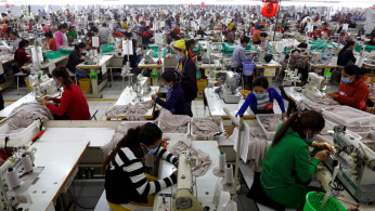 Employees work at a factory supplier of the H&M brand in Kandal province, Cambodia