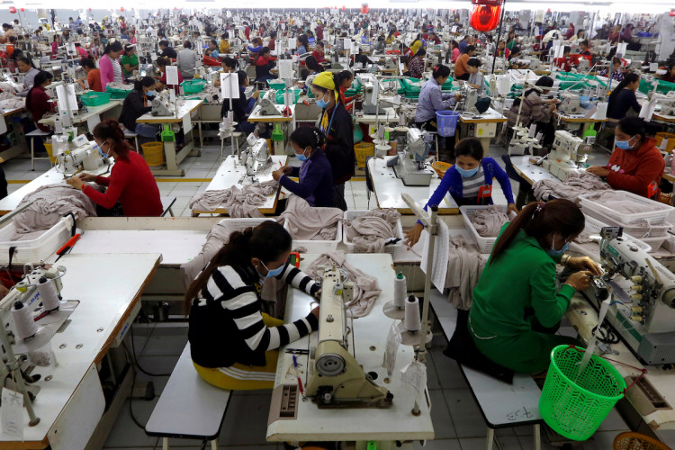 Employees work at a factory supplier of the H&M brand in Kandal province, Cambodia