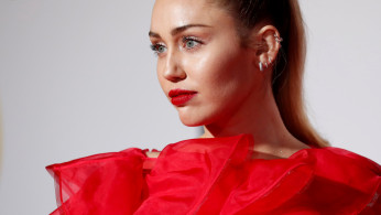 FILE PHOTO: Singer Miley Cyrus poses at the premiere for the movie 