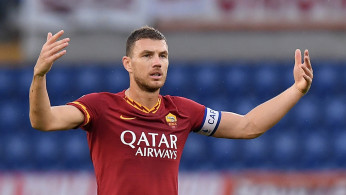 AS Roma's Edin Dzeko gestures at fans after the game is temporarily suspended 