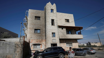 A Palestinian passes a vehicle that was damaged in the southern Nablus, in the Israeli-occupied West Bank November 22, 2019. 