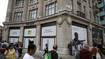 Pedestrians walk past Microsoft's new Oxford Circus store ahead of its opening in London