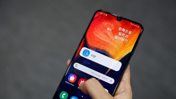 A woman tries out a Samsung Electronic's Galaxy A50 at a Samsung store in Seoul, South Korea, November 14, 2019. 