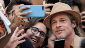 Actor Brad Pitt poses for a photo with fans