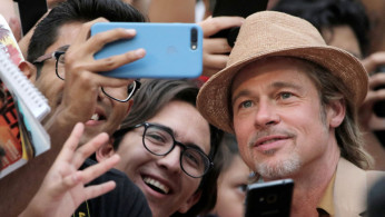 Actor Brad Pitt poses for a photo with fans