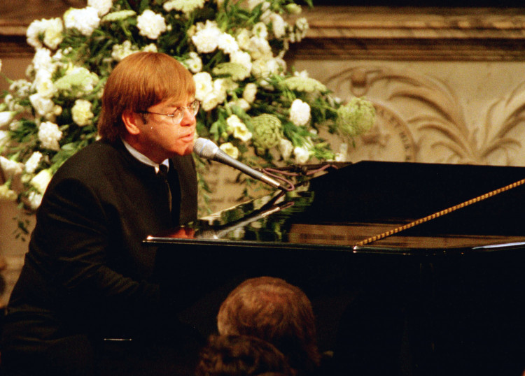 FILE PHOTO: Elton John sings a rewritten version of his song 'Candle in the wind' as a tribute to Diana, Princess of Wales at her funeral in London's Westminster Abbey