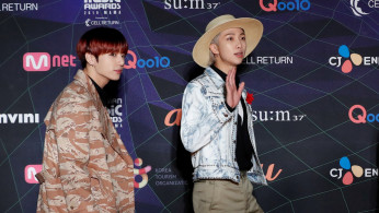 Jungkook and RM, members of South Korean boy band BTS arrive at the red carpet event during the annual MAMA Awards at Nagoya Dome in Nagoya