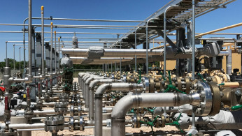 Equipment used to process carbon dioxide, crude oil and water is seen at an Occidental Petroleum Corp enhanced oil recovery project in Hobbs