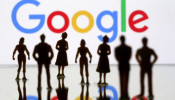 Small toy figures are seen in front of Google logo in this illustration picture