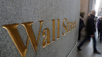 A street sign, Wall Street, is seen outside New York Stock Exchange (NYSE) in New York City, New York