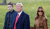 U.S. President Donald Trump walks with son Barron and first lady Melania Trump as they depart for travel to Florida from the South Lawn of the White House in Washington, U.S., November 26, 2019. REUTERS/Tom Brenner