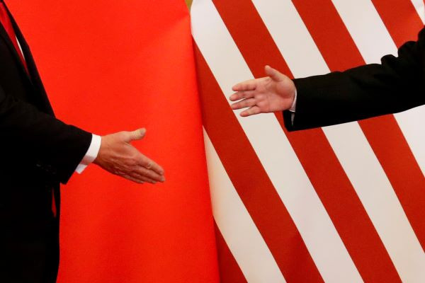  U.S. President Donald Trump and China's President Xi Jinping shake hands in Beijing