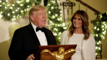 U.S. President Donald Trump with First Lady Melania Trump delivers remarks for the Congressional Ball in the Grand Foyer of the White House in Washington, U.S., December 12, 2019. REUTERS/Yuri Gripas
