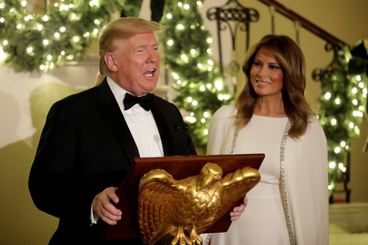 U.S. President Donald Trump with First Lady Melania Trump delivers remarks for the Congressional Ball in the Grand Foyer of the White House in Washington, U.S., December 12, 2019. REUTERS/Yuri Gripas