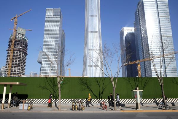 People walk in Beijing's central business area