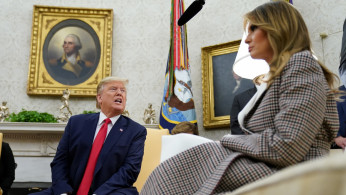 U.S. President Donald Trump speaks next to first lady Melania Trump
