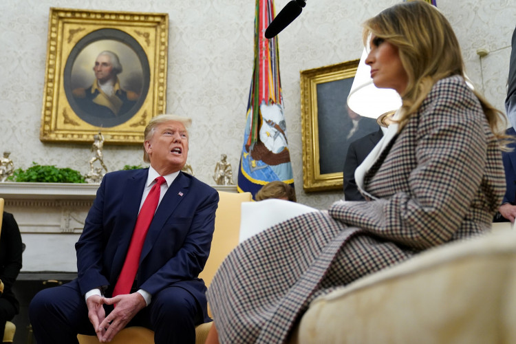 U.S. President Donald Trump speaks next to first lady Melania Trump