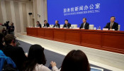 Chinese officials attend a news conference on the state of trade negotiations with U.S. in Beijing