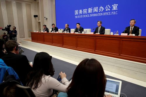 Chinese officials attend a news conference on the state of trade negotiations with U.S. in Beijing