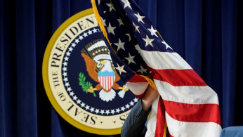 A U.S. flag is put into position before U.S. President Donald Trump arrived to address the 