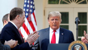 FILE PHOTO: Lighthizer applauds U.S. President Trump as he arrives to discuss trade deal in the Rose Garden of the White House in Washington