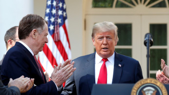FILE PHOTO: Lighthizer applauds U.S. President Trump as he arrives to discuss trade deal in the Rose Garden of the White House in Washington