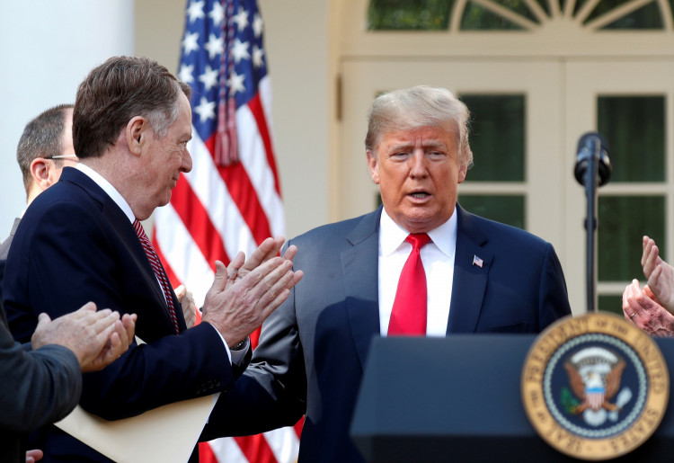 FILE PHOTO: Lighthizer applauds U.S. President Trump as he arrives to discuss trade deal in the Rose Garden of the White House in Washington
