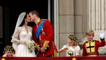 FILE PHOTO: Britain's Prince William and his wife Catherine, Duchess of Cambridge, kiss on the balcony at Buckingham Palace after their wedding in Westminster Abbey in London