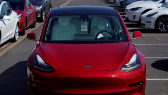 FILE PHOTO: A new Tesla Model 3 is shown at a delivery center on the last day of the company's third quarter, in San Diego