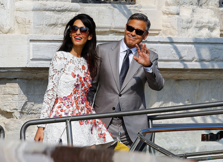FILE PHOTO: U.S. actor George Clooney and his wife Amal Alamuddin leave the seven-star hotel Aman Canal Grande Venice in Venice September 28, 2014. REUTERS/Stefano Rellandini/File Photo