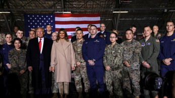 U.S. President Donald Trump and first lady Melania Trump pose for a group photo at a signing ceremony of the 
