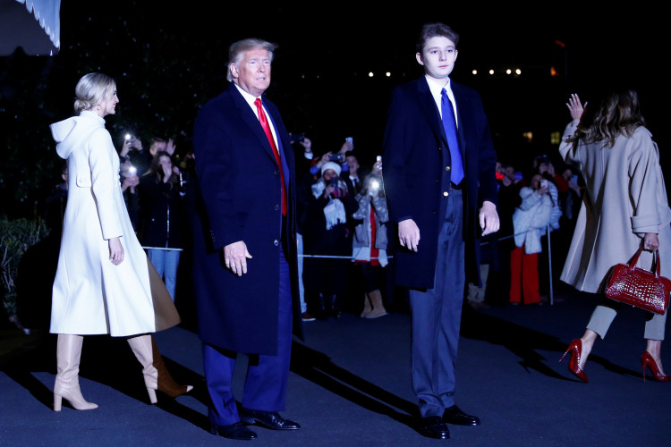 U.S. President Donald Trump looks on beside his son, Barron, as Senior Advisor Ivanka Trump and first lady Melania Trump walk to Marine One at the White House in Washington, U.S., December 20, 2019. REUTERS/Tom Brenner