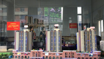 A model showing a residential and commercial compound is seen at a real estate showroom in Yanan