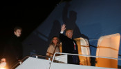 U.S. President Donald Trump waves as he boards the Air Force One with first lady Melania Trump and son Barron after signing the 