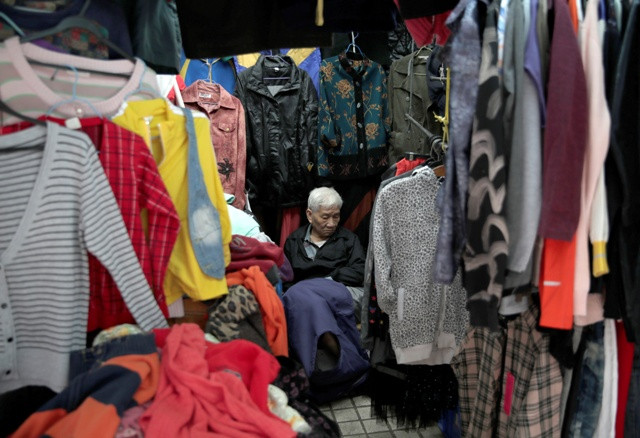 An elderly vendor waits for customers in his roadside stall in Macau
