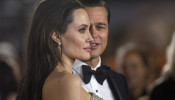 FILE PHOTO: Director and cast member Angelina Jolie and her husband and co-star Brad Pitt pose at the premiere of 