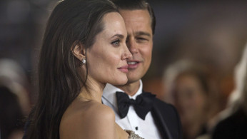 FILE PHOTO: Director and cast member Angelina Jolie and her husband and co-star Brad Pitt pose at the premiere of 