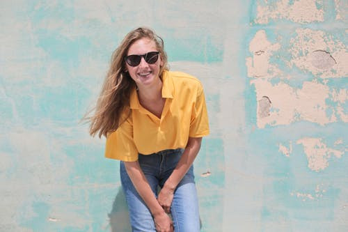 Woman wearing yellow polo shirt.