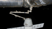 The SpaceX Dragon commercial cargo craft is grappled by the Canadarm2 robotic arm