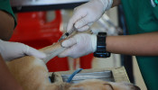 Vet vaccinating a dog.