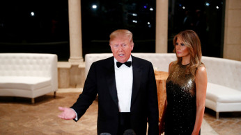 U.S. President Donald Trump accompanied by first lady Melania Trump, speaks to the press at the Mar-a-Lago resort in Palm Beach