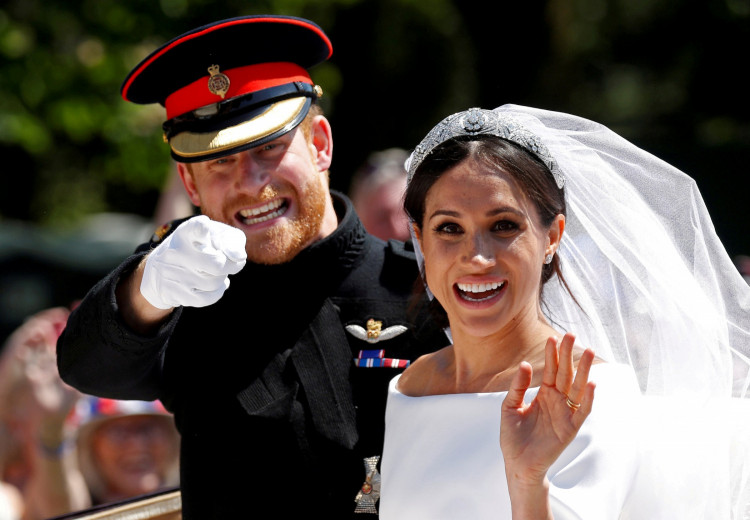 Britain's Prince Harry gestures next to his wife Meghan 