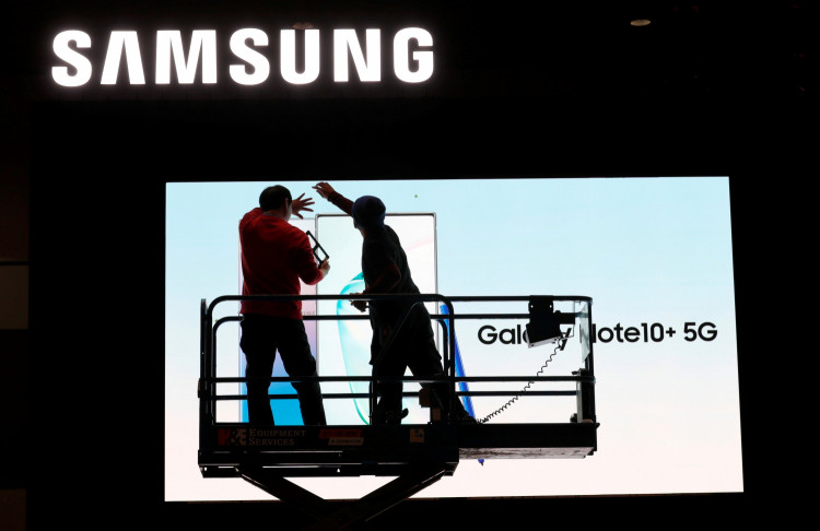 FILE PHOTO: Workers set up a Samsung display in the lobby of the Las Vegas Convention Center in preparation for the 2020 CES trade fair in Las Vegas