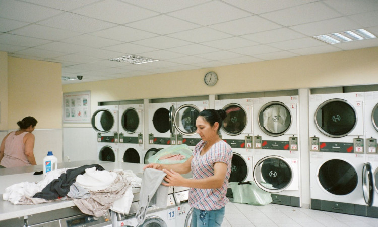 Photo of a woman washing her clothes. 