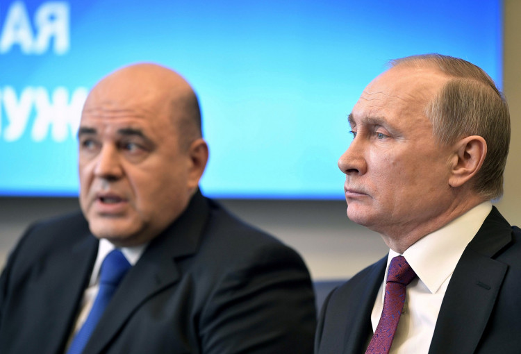 Russian President Vladimir Putin attends a meeting with head of the Federal Taxation Service Mikhail Mishustin in Moscow