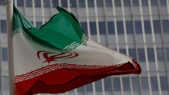 An Iranian flag flutters in front of the International Atomic Energy Agency (IAEA) headquarters in Vienna